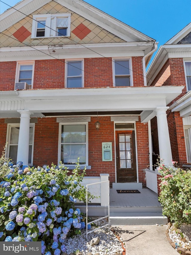 view of exterior entry with covered porch