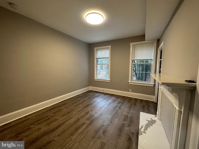 unfurnished room featuring dark wood-type flooring