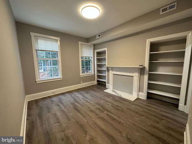 unfurnished living room featuring dark hardwood / wood-style flooring