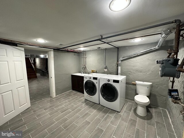 laundry area featuring independent washer and dryer and light wood-type flooring