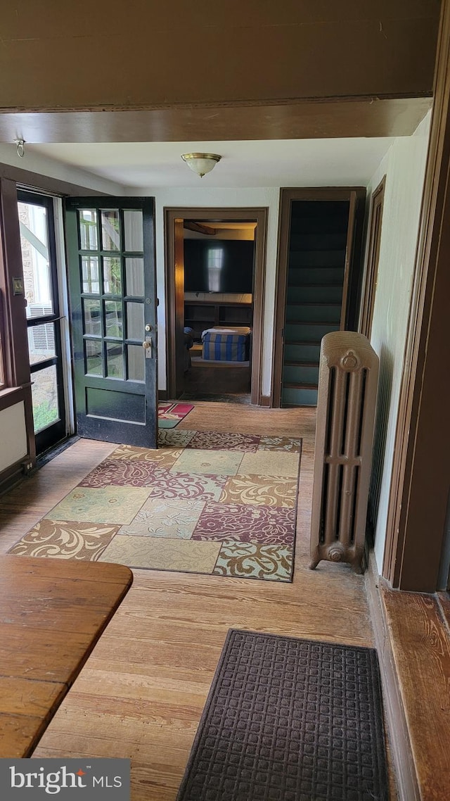 hall with hardwood / wood-style flooring