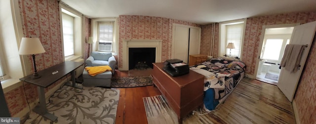 living room featuring plenty of natural light, cooling unit, and hardwood / wood-style floors