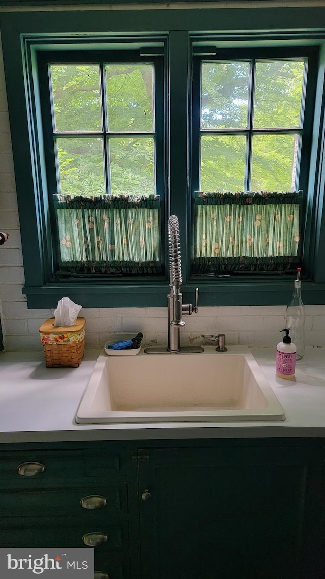 bathroom with decorative backsplash and sink