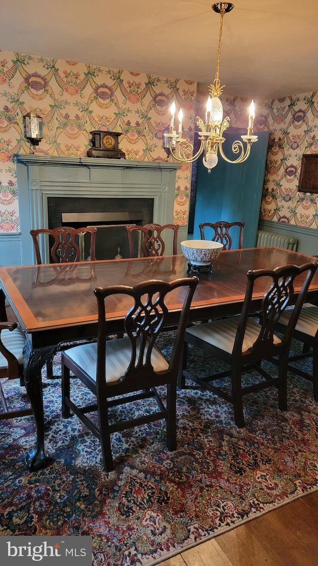 dining area with an inviting chandelier and hardwood / wood-style floors