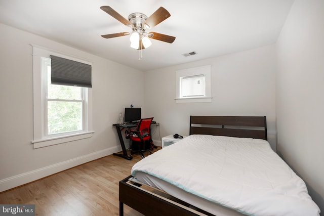 bedroom with light hardwood / wood-style flooring and ceiling fan