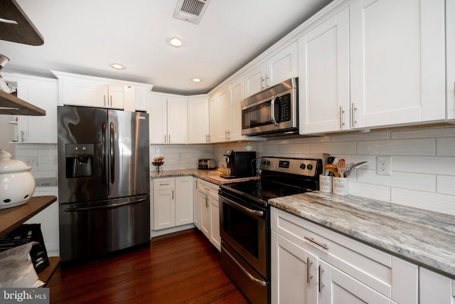 kitchen featuring dark hardwood / wood-style floors, white cabinets, and appliances with stainless steel finishes