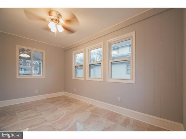 unfurnished room with ceiling fan