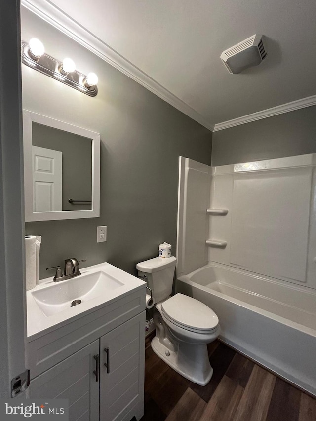 full bathroom with hardwood / wood-style floors, vanity, toilet, ornamental molding, and  shower combination