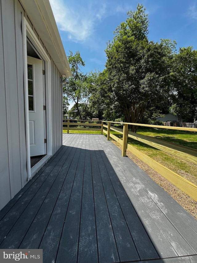 wooden deck with a yard