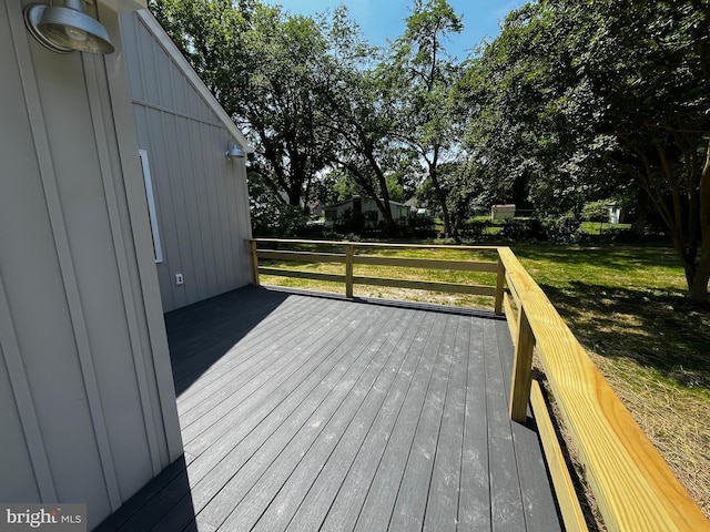 wooden deck featuring a yard