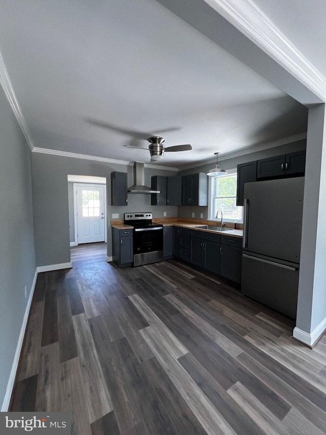 kitchen featuring stainless steel electric stove, wall chimney exhaust hood, dark wood-type flooring, fridge, and crown molding