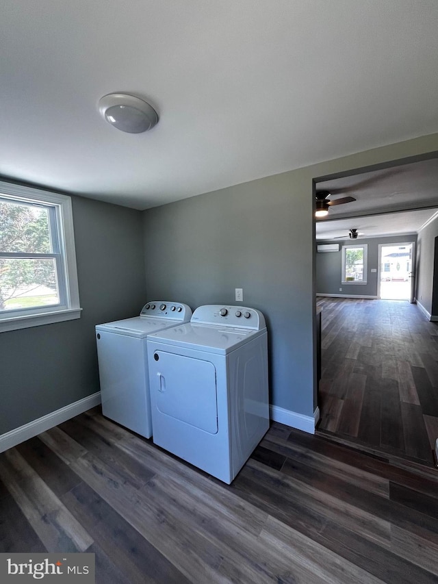 clothes washing area with washer and dryer, dark hardwood / wood-style floors, and ceiling fan