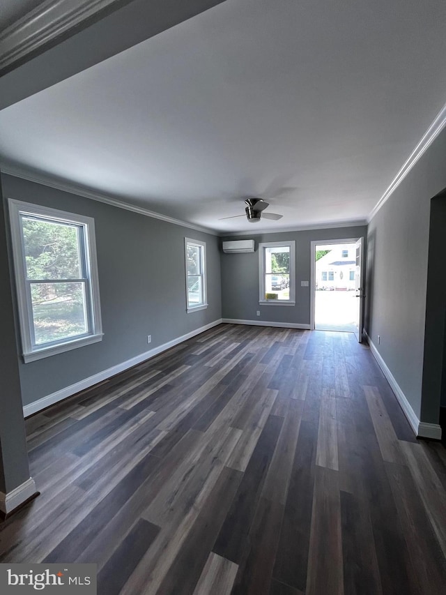 empty room featuring ceiling fan, dark wood-type flooring, crown molding, and a wall mounted air conditioner