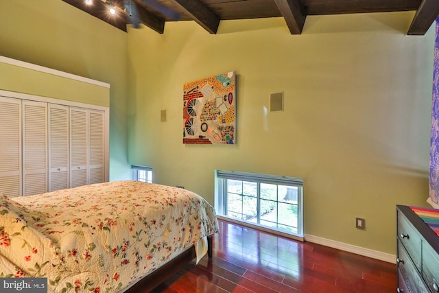 bedroom featuring beamed ceiling, dark hardwood / wood-style floors, high vaulted ceiling, and a closet