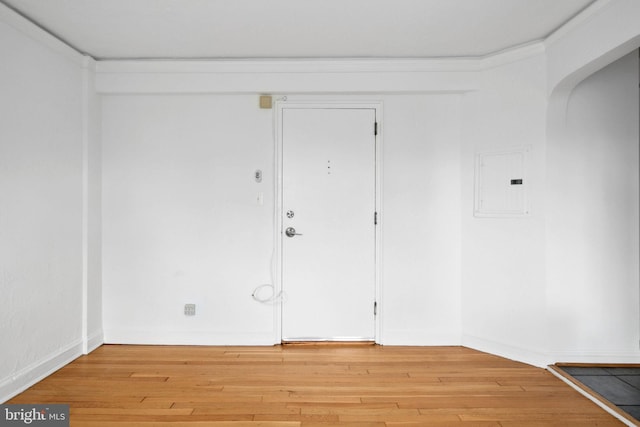 foyer with electric panel and light hardwood / wood-style flooring