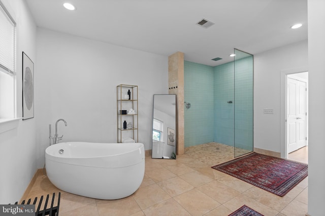 bathroom with tile patterned flooring and independent shower and bath