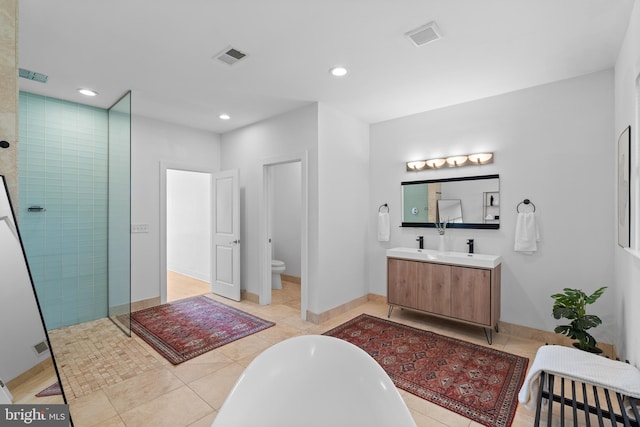 full bathroom featuring toilet, shower with separate bathtub, vanity, and tile patterned floors