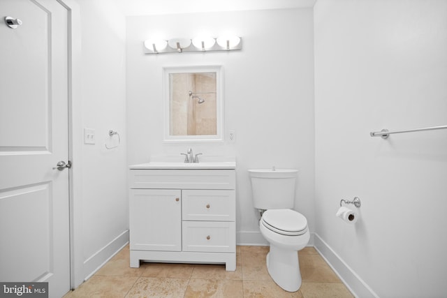 bathroom featuring tile patterned floors, vanity, and toilet