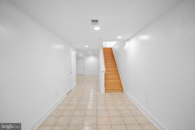 corridor with light tile patterned flooring