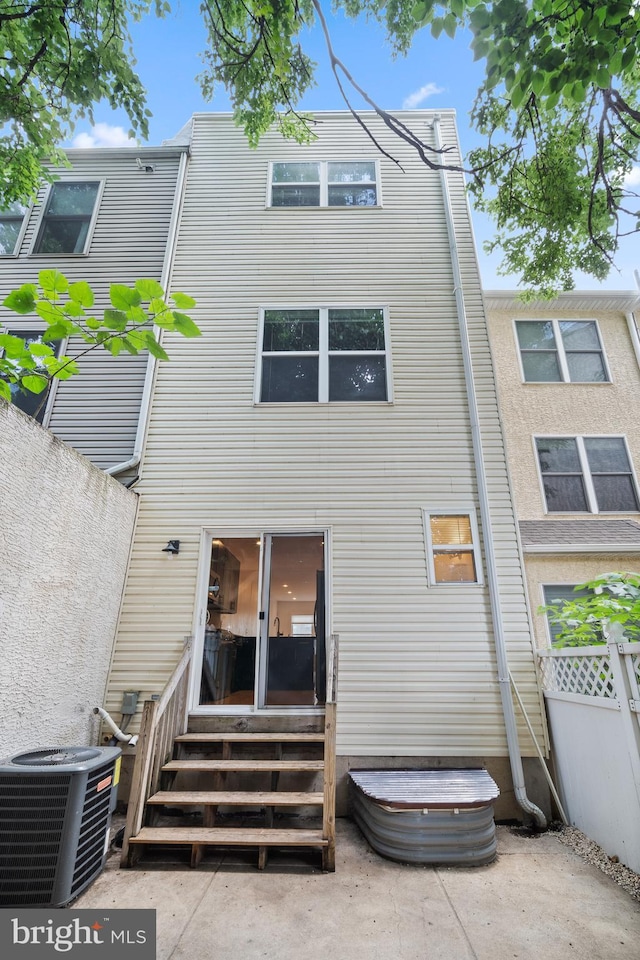 rear view of property featuring central AC