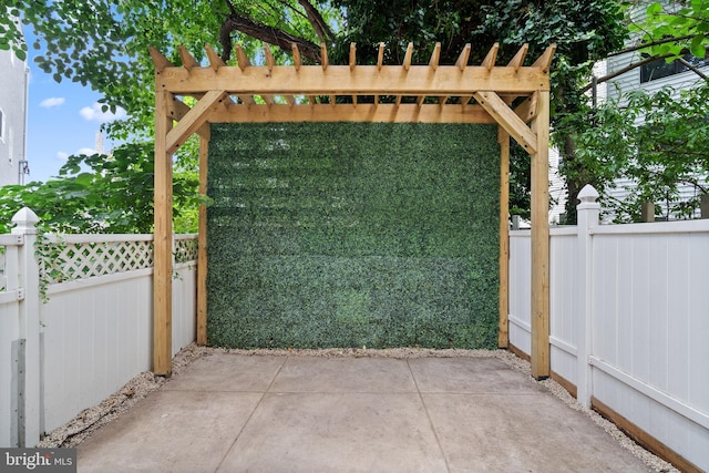 view of gate featuring a patio area