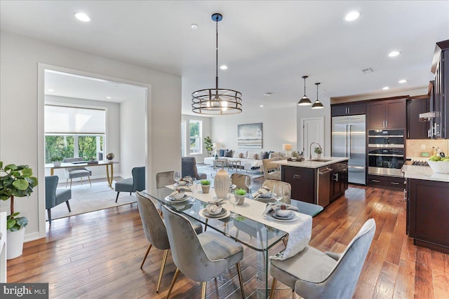 dining area featuring dark hardwood / wood-style flooring and sink