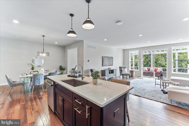 kitchen featuring hanging light fixtures, hardwood / wood-style floors, sink, and plenty of natural light