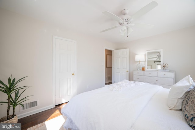 bedroom with dark hardwood / wood-style floors and ceiling fan