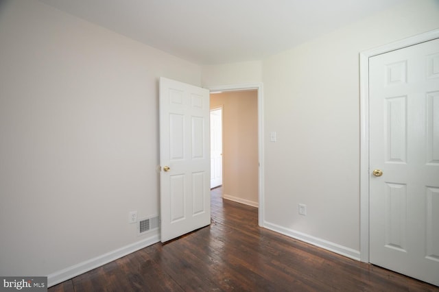 unfurnished bedroom featuring dark hardwood / wood-style floors