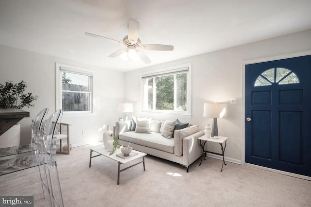 living room with ceiling fan and light colored carpet