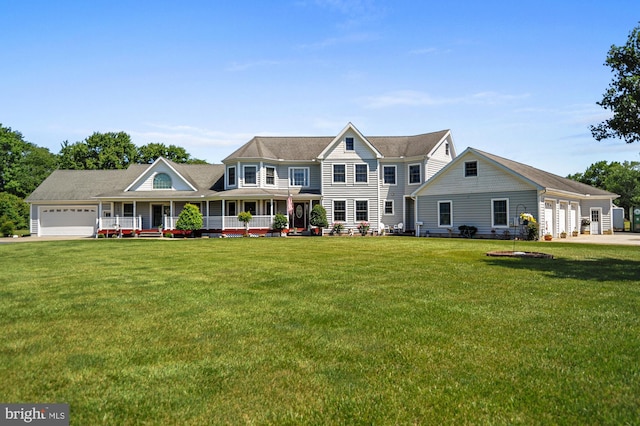 view of front facade featuring covered porch, a front yard, and a garage