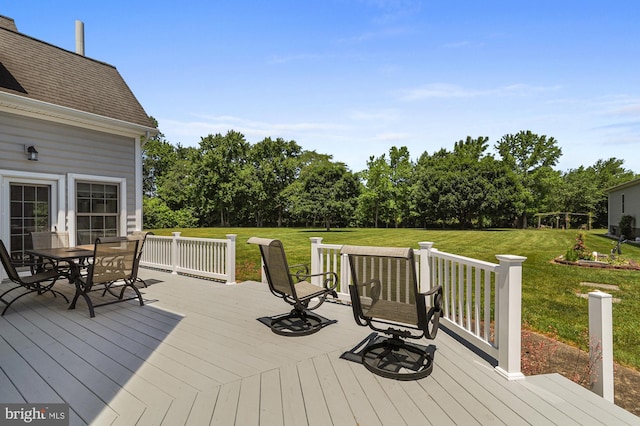 wooden terrace with a lawn