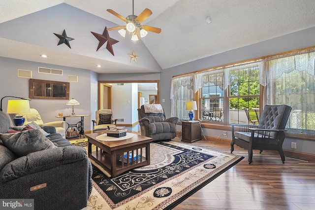 living room with ceiling fan, dark hardwood / wood-style flooring, lofted ceiling, and a textured ceiling