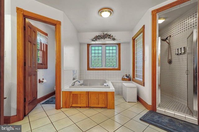 bathroom featuring plenty of natural light, independent shower and bath, and tile patterned flooring