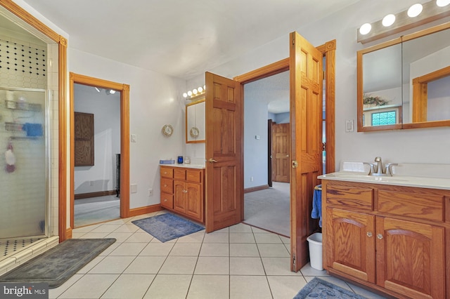 bathroom featuring tile patterned floors, vanity, and an enclosed shower