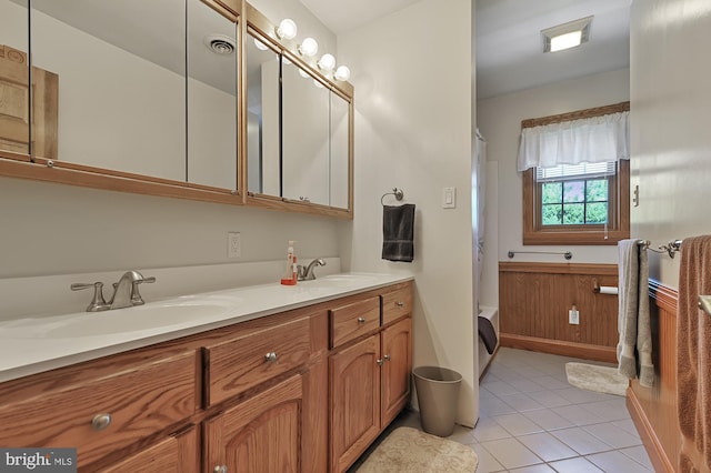 bathroom featuring tile patterned flooring, vanity, and shower / tub combo