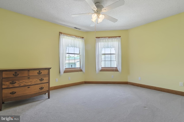 unfurnished room with light carpet, a textured ceiling, and ceiling fan