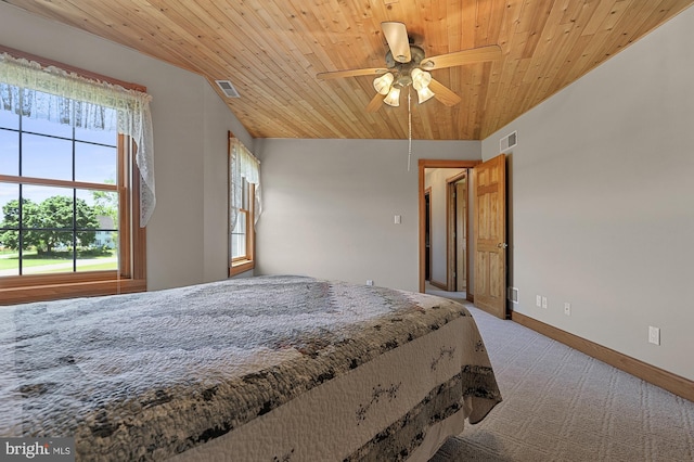 carpeted bedroom featuring wood ceiling, multiple windows, and ceiling fan