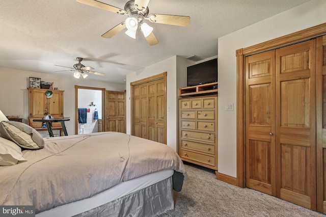 carpeted bedroom featuring a textured ceiling and ceiling fan