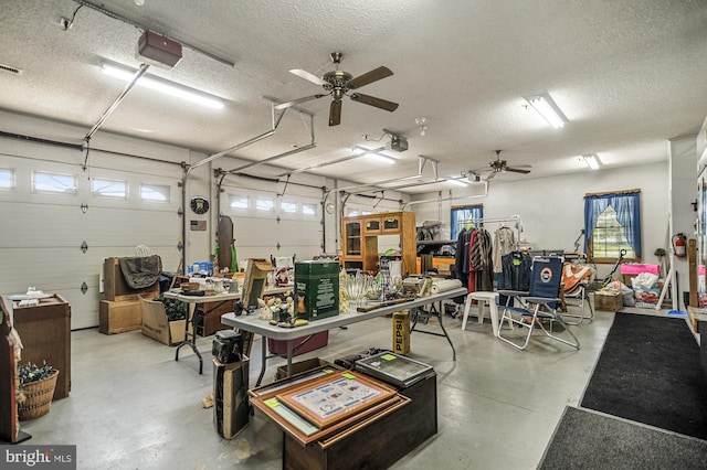 garage featuring a workshop area, ceiling fan, and a garage door opener