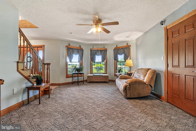 sitting room with carpet, ceiling fan, and a textured ceiling