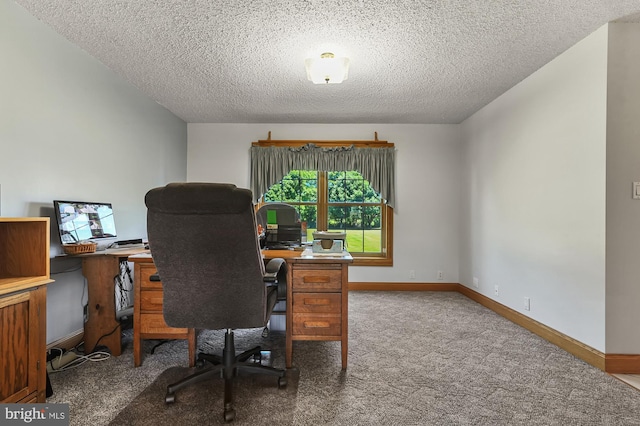 carpeted home office with a textured ceiling