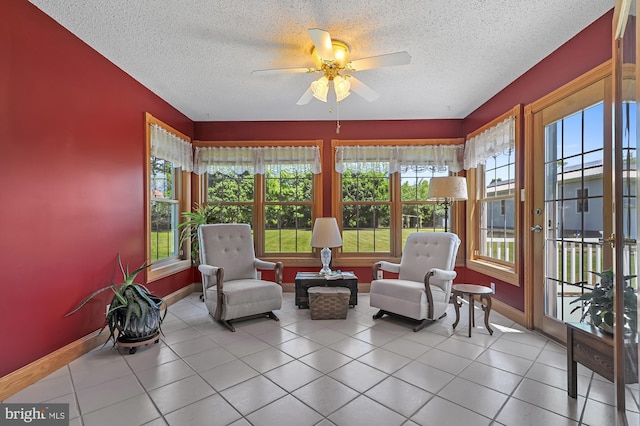 sunroom / solarium featuring ceiling fan