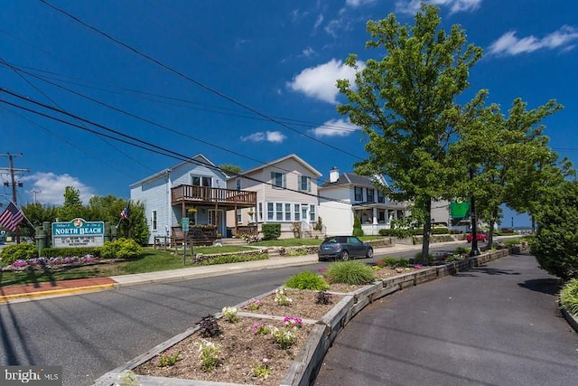 view of street featuring curbs and a residential view