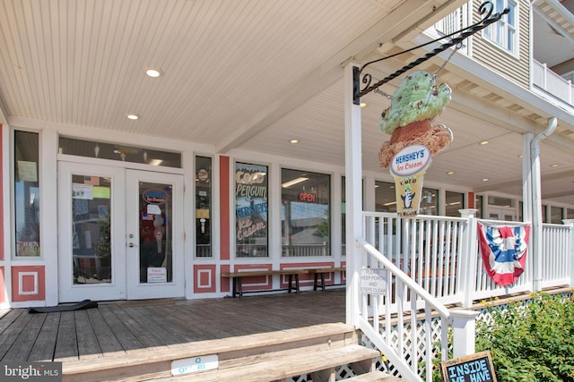 entrance to property featuring covered porch and french doors