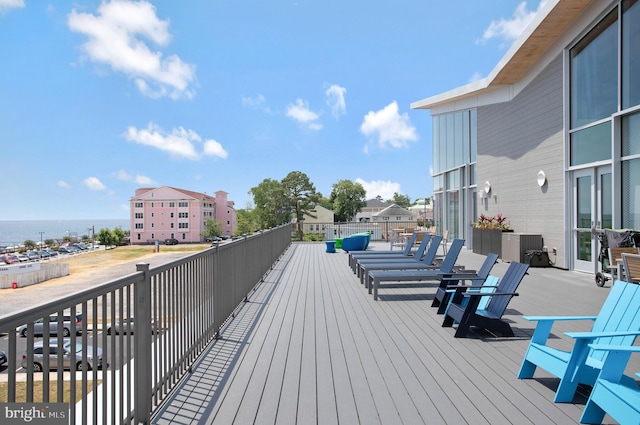 wooden terrace featuring a water view