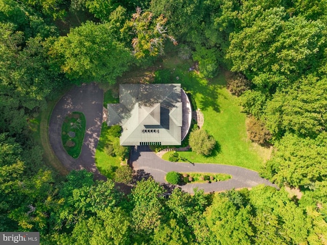 drone / aerial view featuring a wooded view