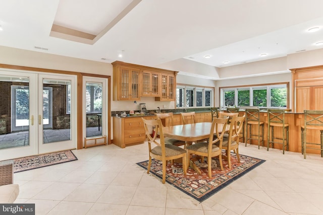 dining space featuring visible vents, a tray ceiling, light tile patterned floors, recessed lighting, and french doors