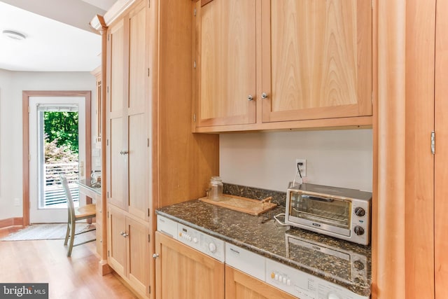 kitchen with light wood-style floors, light brown cabinetry, and a toaster