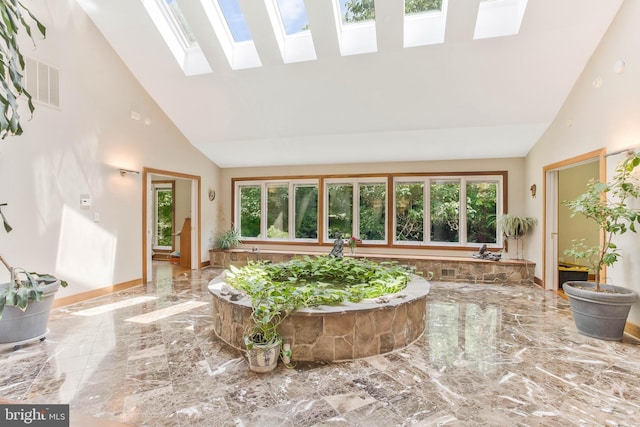 sunroom / solarium with visible vents and vaulted ceiling with skylight